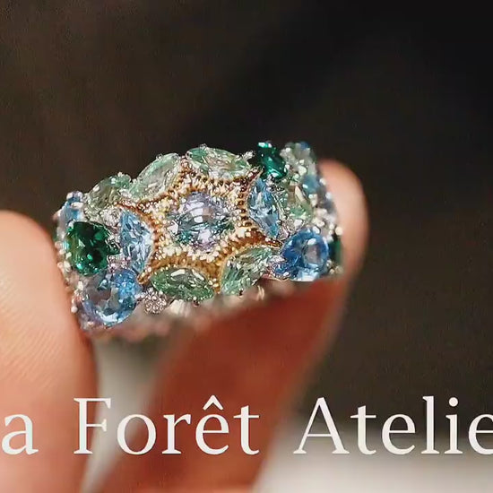 Colorful gemstone ring with marquise-cut green and blue stones

