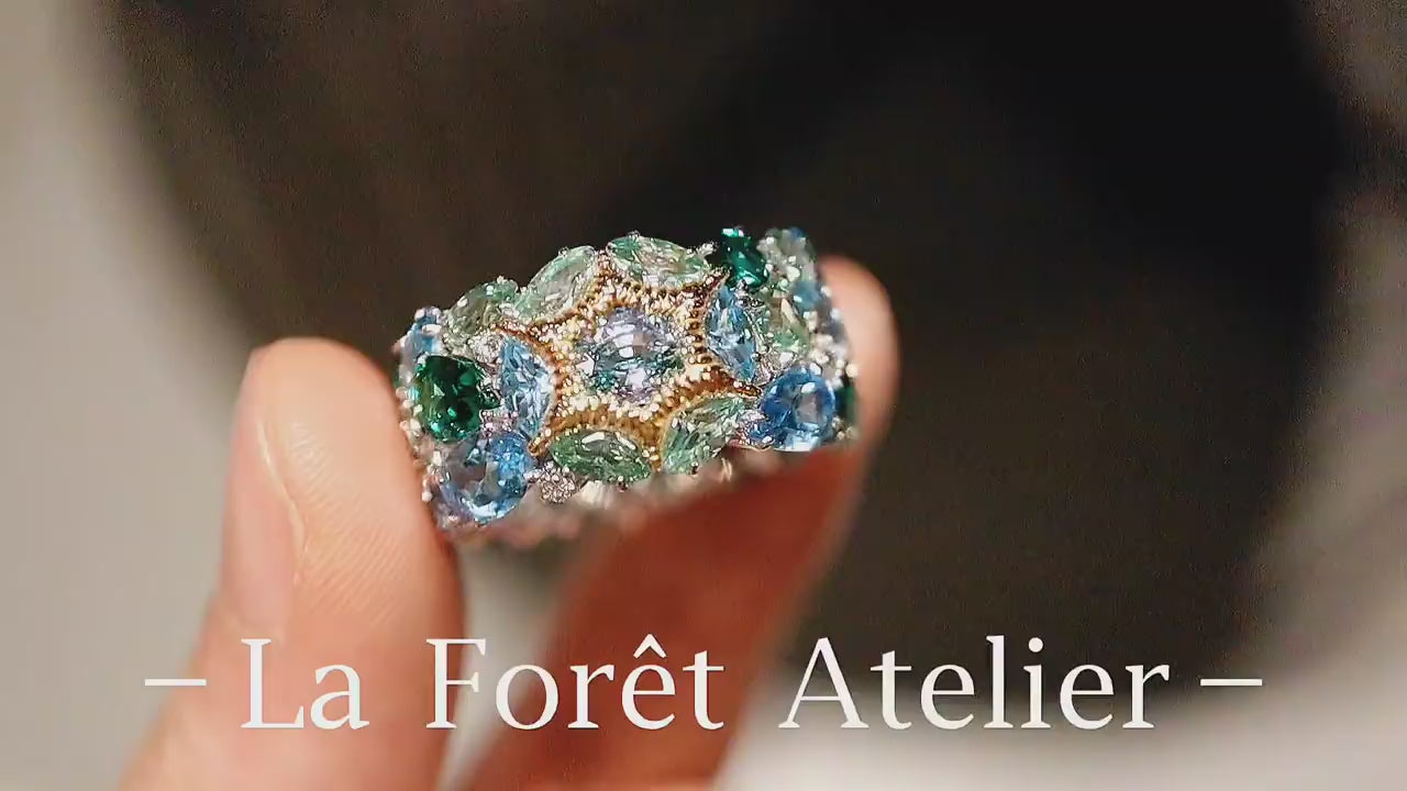 Colorful gemstone ring with marquise-cut green and blue stones

