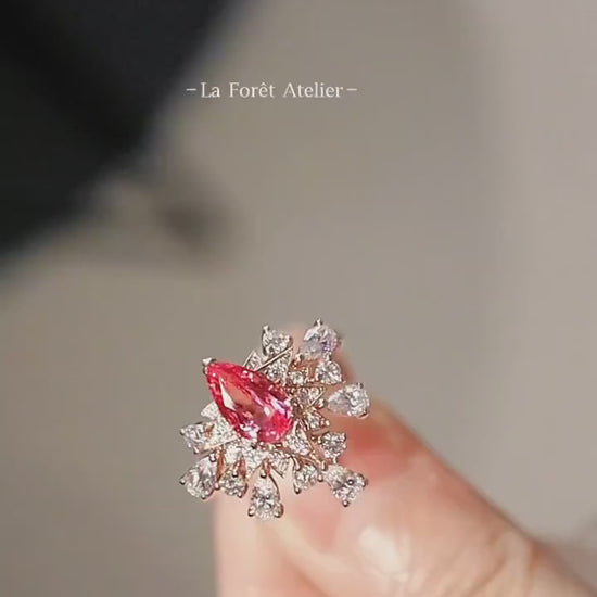 Zelara gold ring with 5x7mm pear-cut pink sapphire and starburst halo of lab-grown white stones








