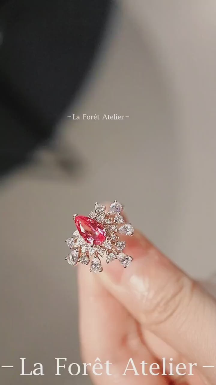Zelara gold ring with 5x7mm pear-cut pink sapphire and starburst halo of lab-grown white stones








