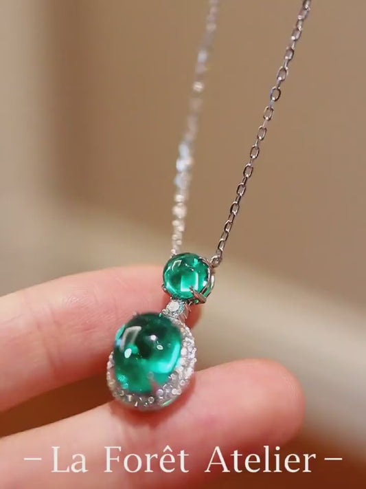 Nirelle pendant necklace with 3ct and 1ct lab-grown emerald cabochons and diamond halo in white gold








