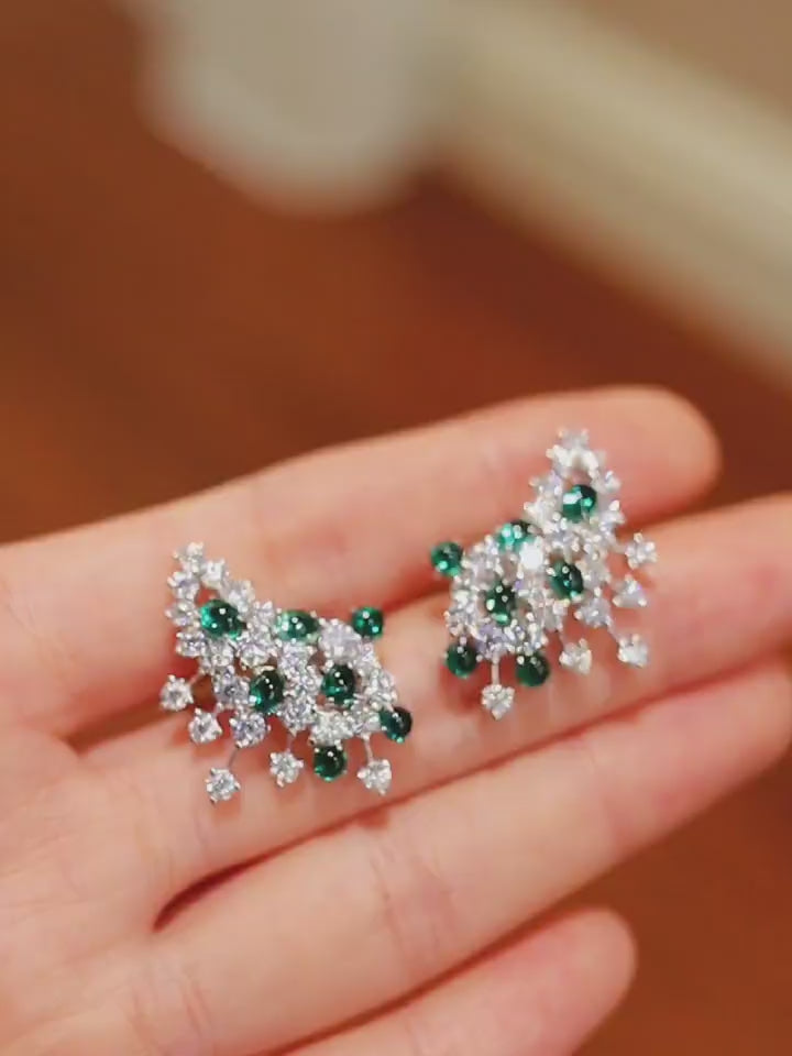 Caelia statement earrings with lab-grown emeralds and diamonds in a white gold floral design








