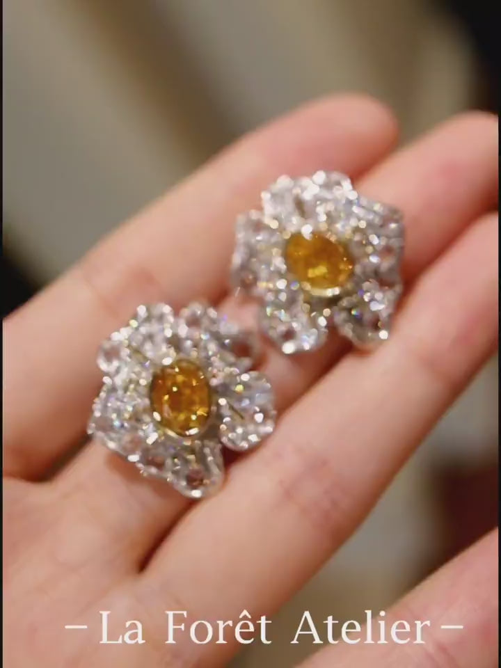 Flora Aurelia earrings feature 1ct lab-grown yellow diamonds with rose-cut lab diamond petals in a radiant floral design.








