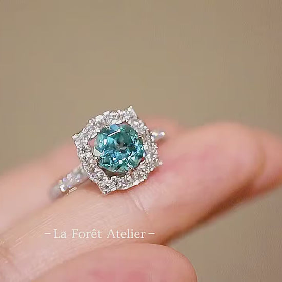 Vintage-style engagement ring with round blue center stone

