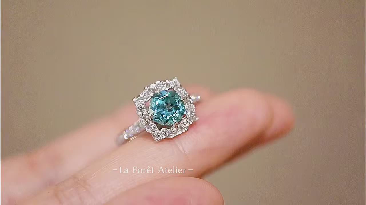 Vintage-style engagement ring with round blue center stone

