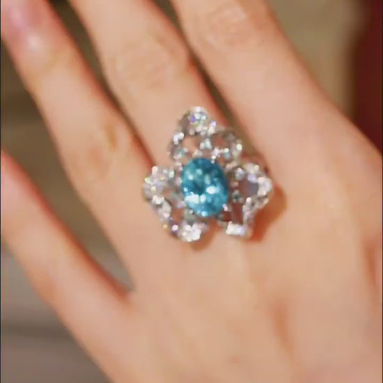 Floral-inspired ring with a 5ct natural apatite center and shimmering diamond petals









