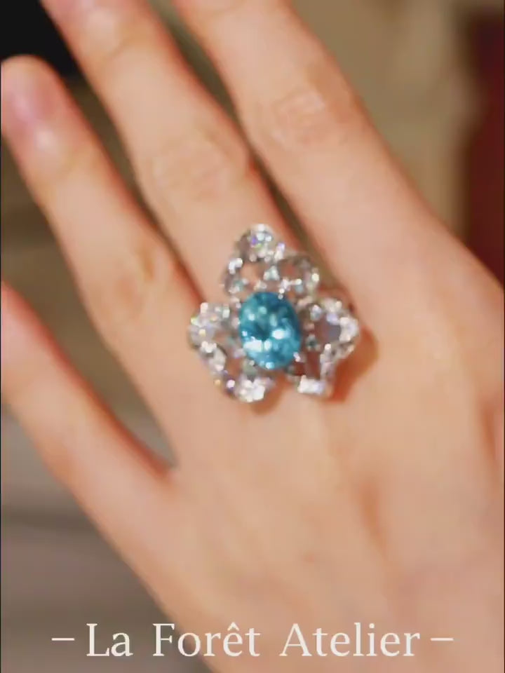 Floral-inspired ring with a 5ct natural apatite center and shimmering diamond petals








