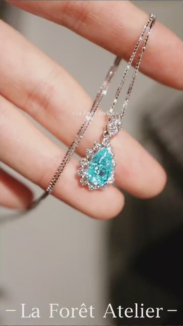 Pear-shaped Paraiba halo necklace with diamonds


