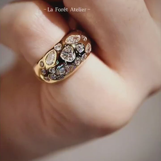 Close-up of Celeste gold dome ring with pear and marquise diamonds