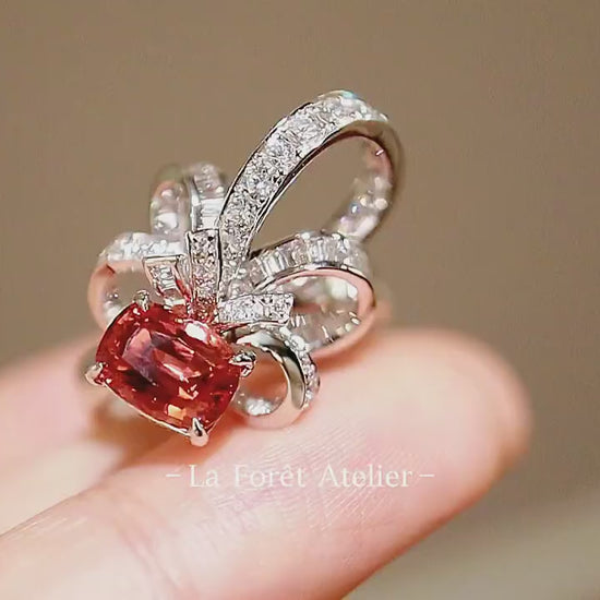 Pink-peach sapphire ring with lab diamond petal halo

