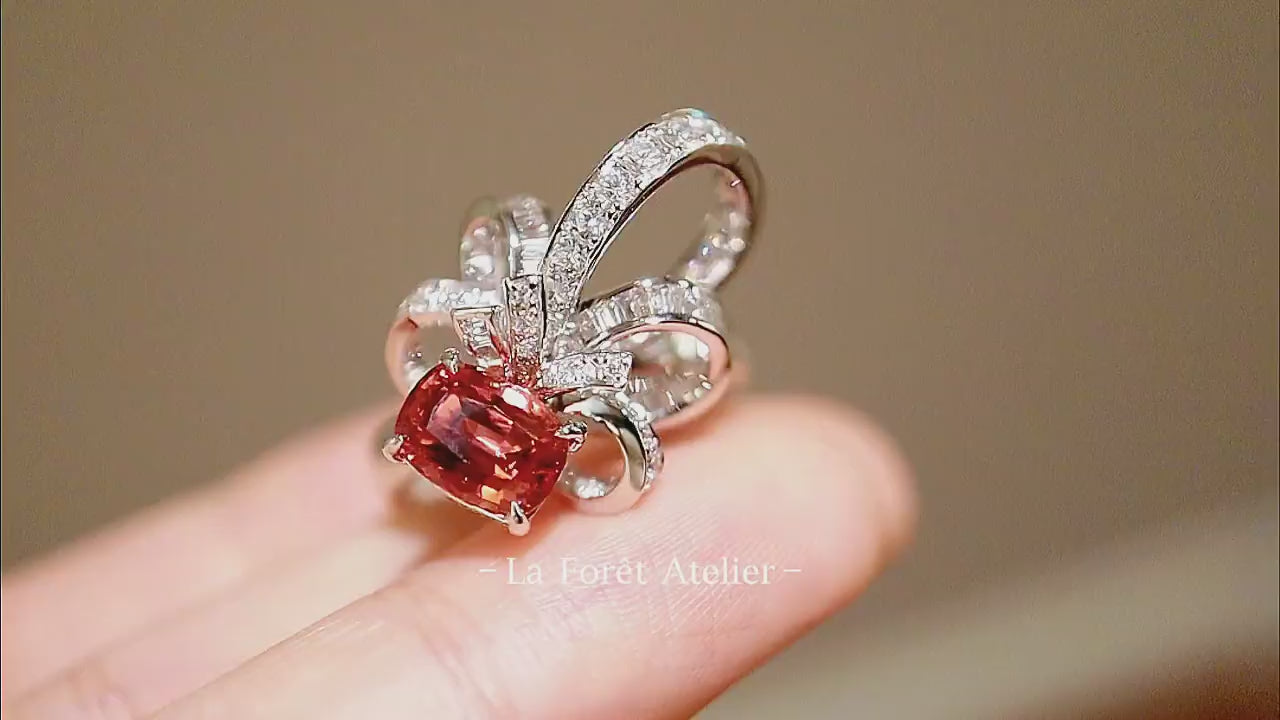 Pink-peach sapphire ring with lab diamond petal halo

