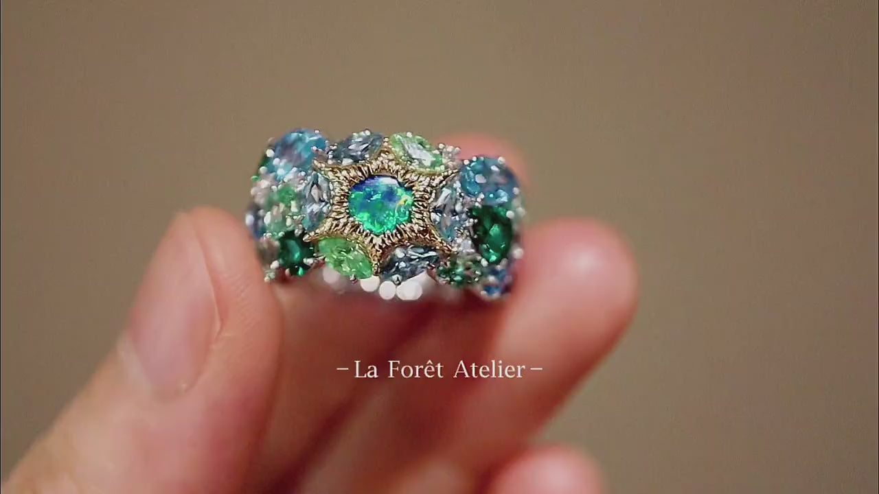 Serastra ring with doublet opal, tsavorite, and aquamarine in starburst cluster design