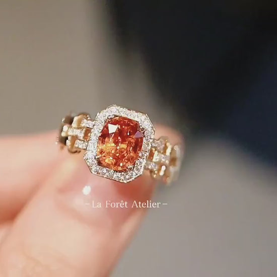 Art Deco-inspired ring featuring vivid orange garnet center

