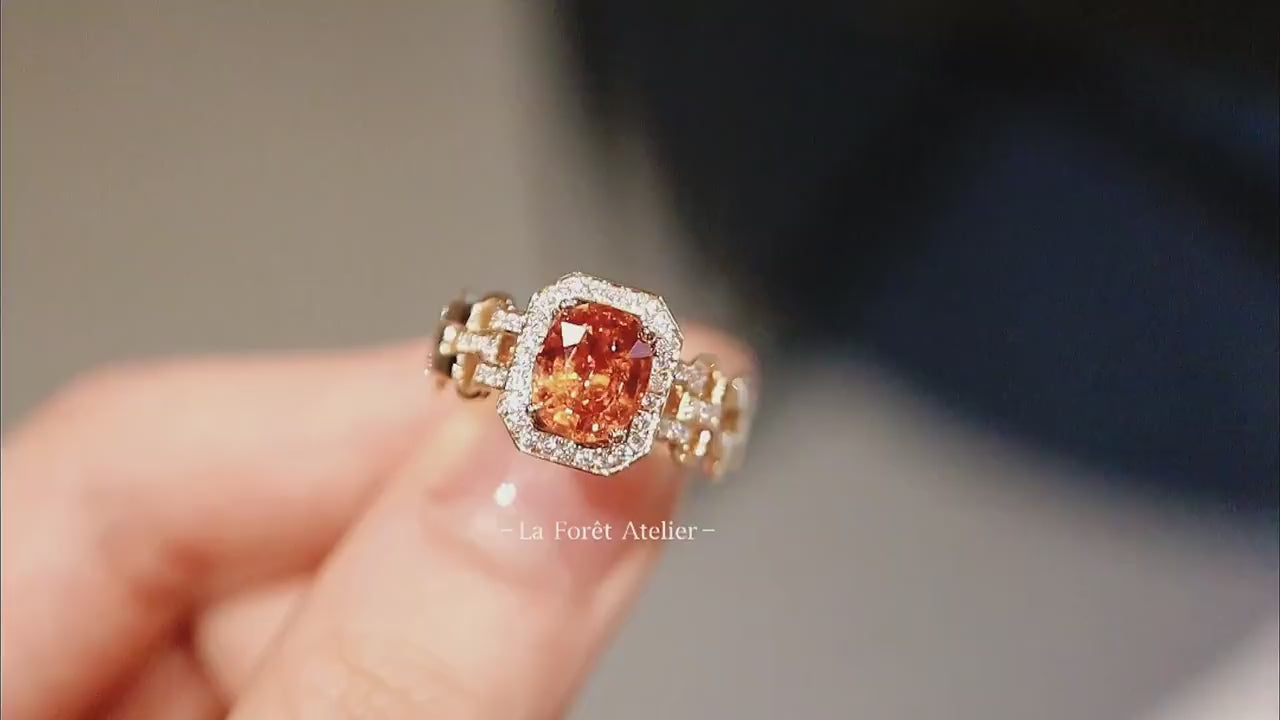 Art Deco-inspired ring featuring vivid orange garnet center


