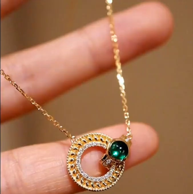 Gold medallion necklace with lab emerald cabochon and pavé diamond accents








