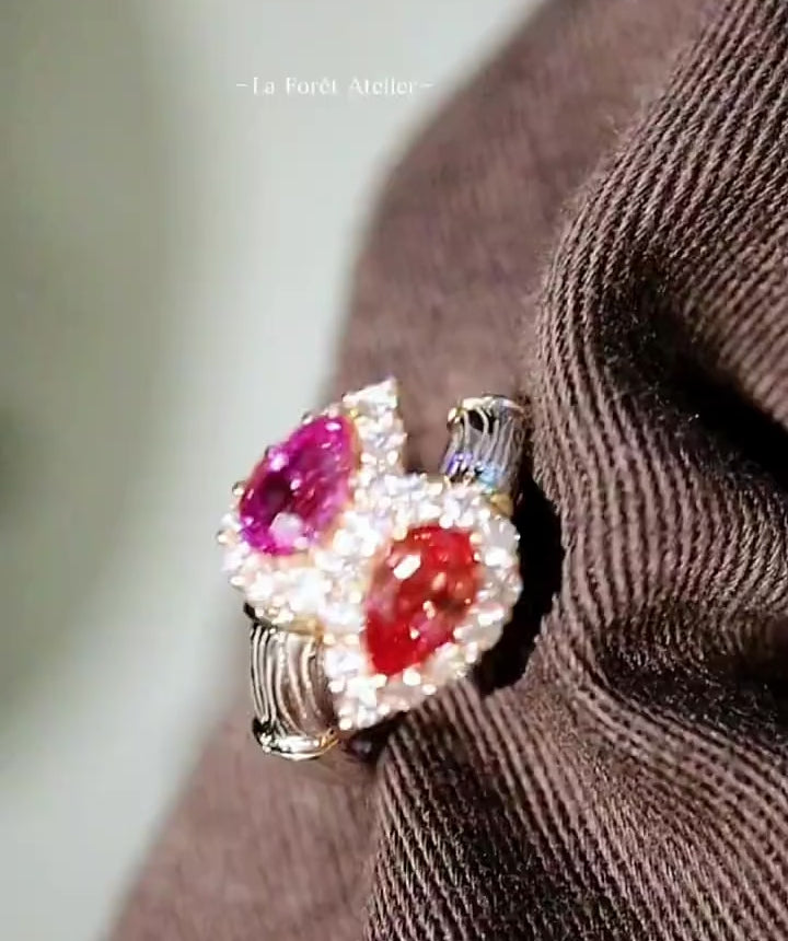 Toi et Moi gold ring with pear-cut lab pink diamond and padparadscha sapphire surrounded by diamond halos