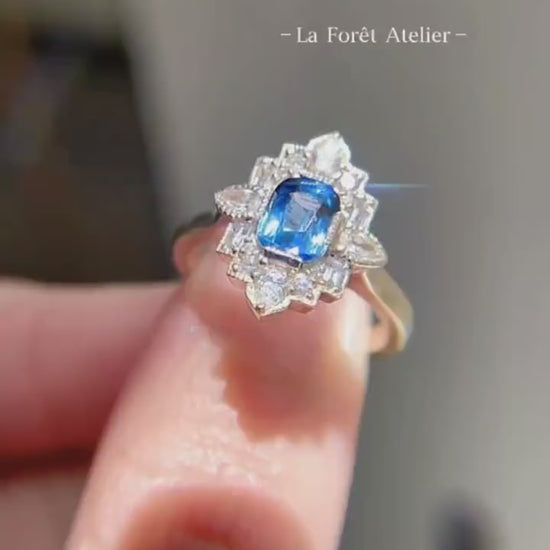 Lab-grown blue sapphire ring with floral diamond halo design








