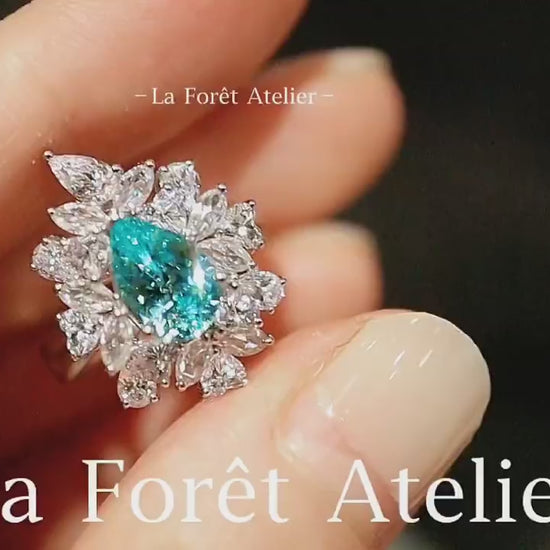 Elegant pear-cut paraiba and diamond floral halo ring








