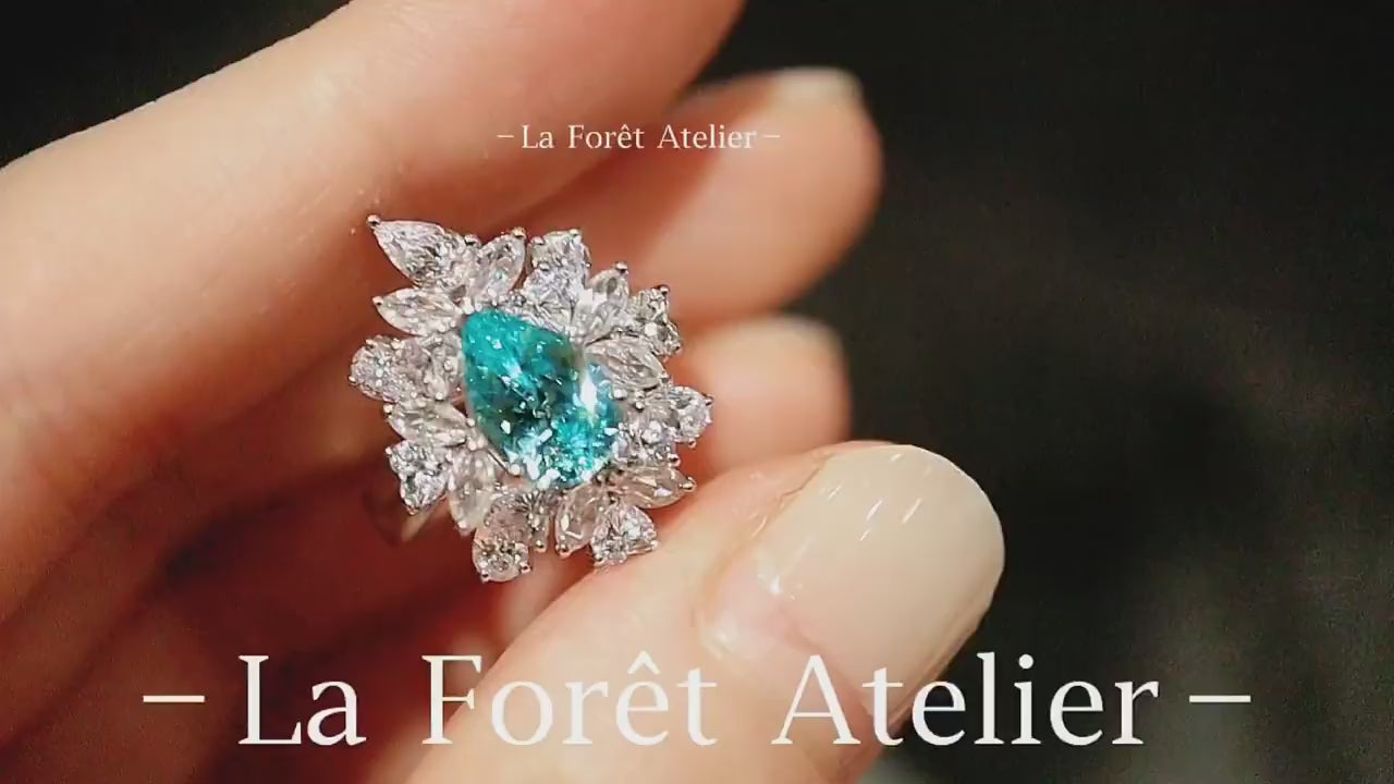Elegant pear-cut paraiba and diamond floral halo ring








