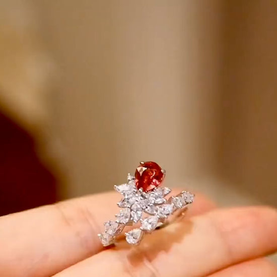Pear-cut lab sapphire ring with diamond leaf design in white gold








