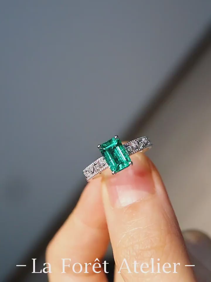 1ct emerald-cut lab emerald ring with diamond band in white gold setting








