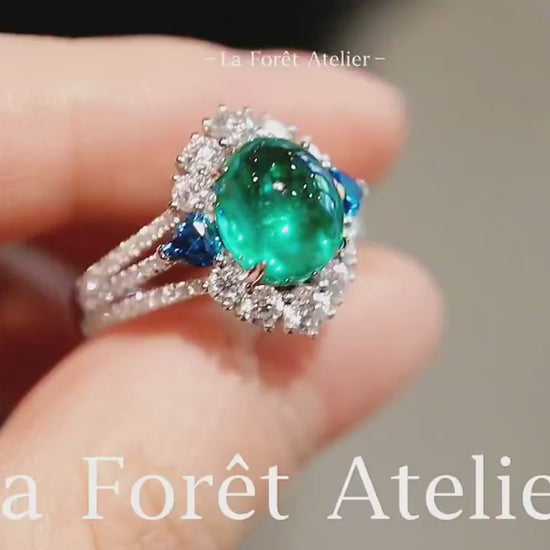 Lab-grown cabochon emerald ring with sapphire side accents