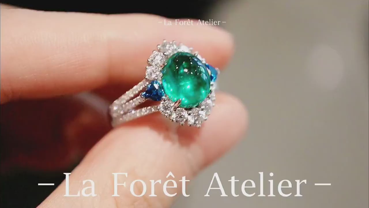 Lab-grown cabochon emerald ring with sapphire side accents