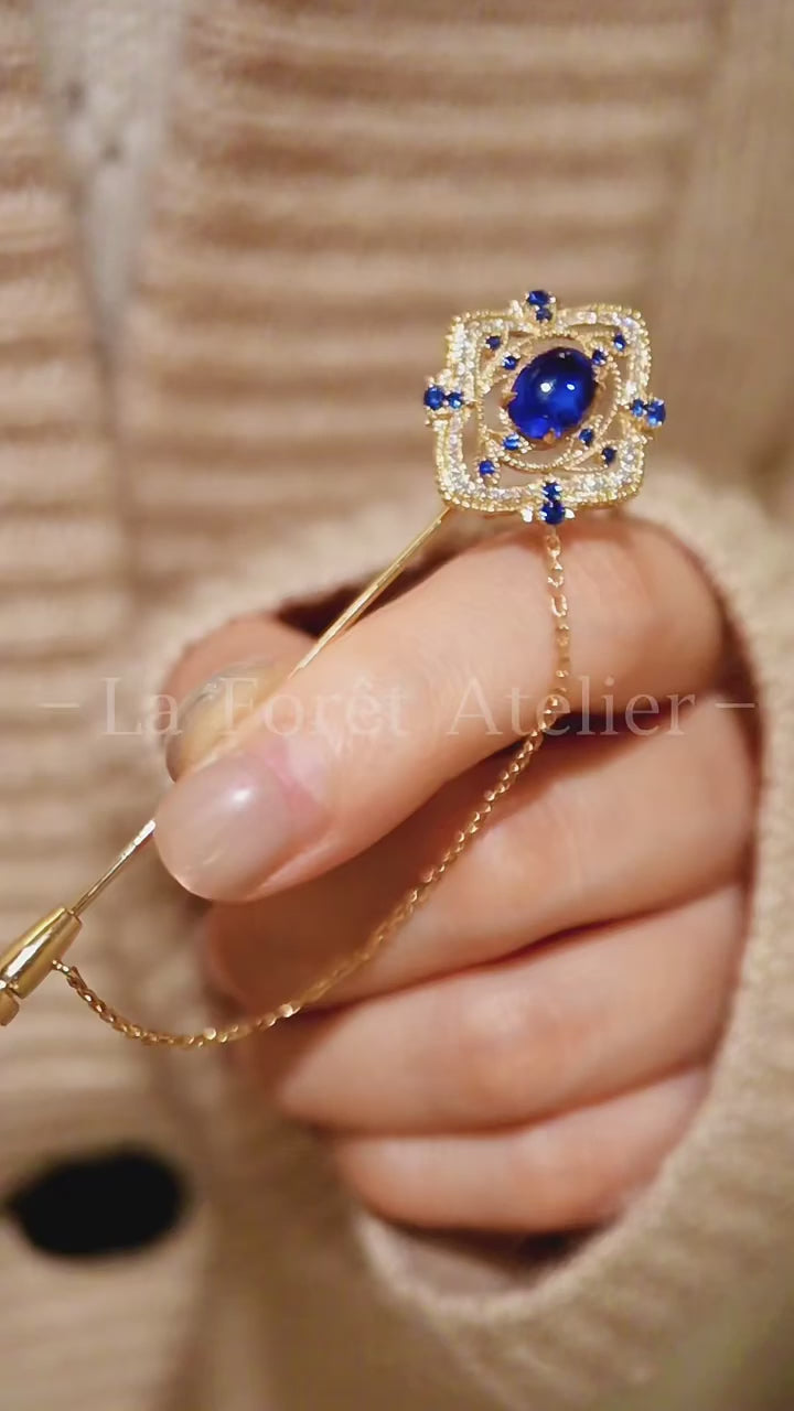 Azurien 2ct lab sapphire brooch pendant with gold detailing and blue accent stones








