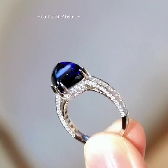 7ct lab-grown royal blue sugarloaf sapphire ring with pavé lab diamonds and split band setting








