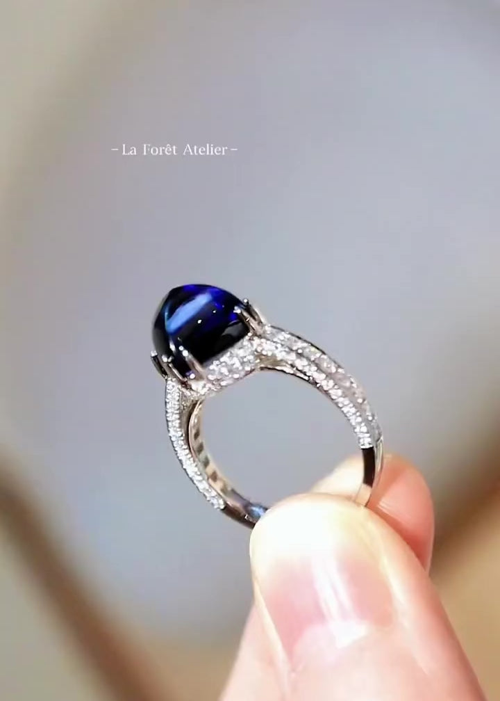 7ct lab-grown royal blue sugarloaf sapphire ring with pavé lab diamonds and split band setting








