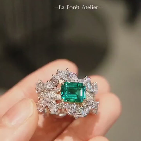 Crown-inspired lab emerald ring with complete diamond wrap









