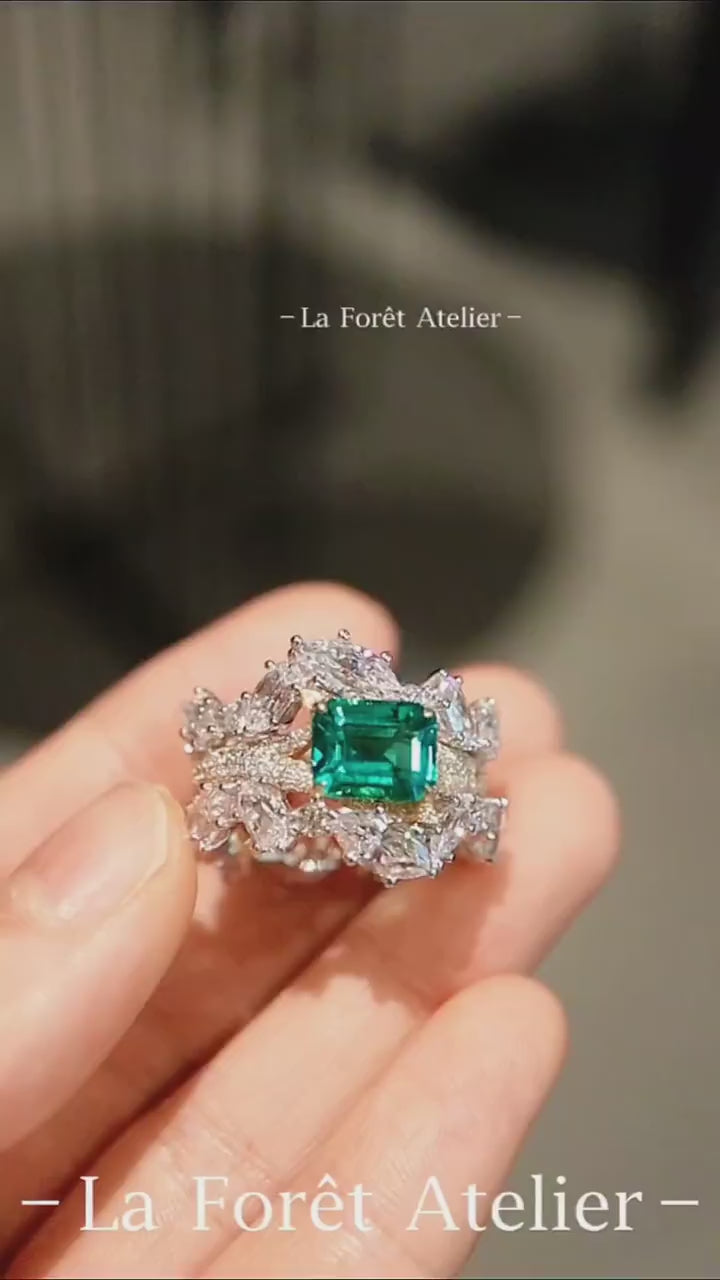 Crown-inspired lab emerald ring with complete diamond wrap








