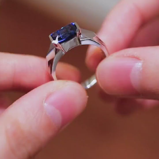 Modern bezel-set ring with 2ct emerald-cut lab-grown sapphire in silver band








