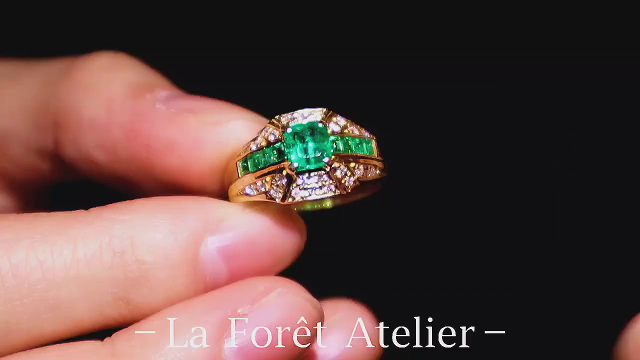 Lab emerald cushion ring with diamond accents in gold setting








