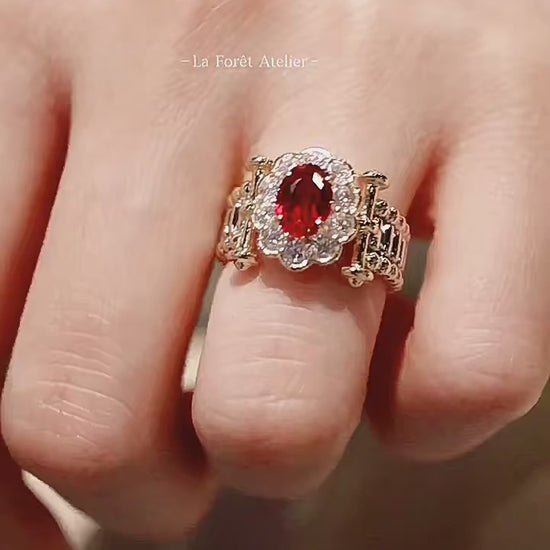 Oval pigeon blood ruby ring with scalloped diamond setting

