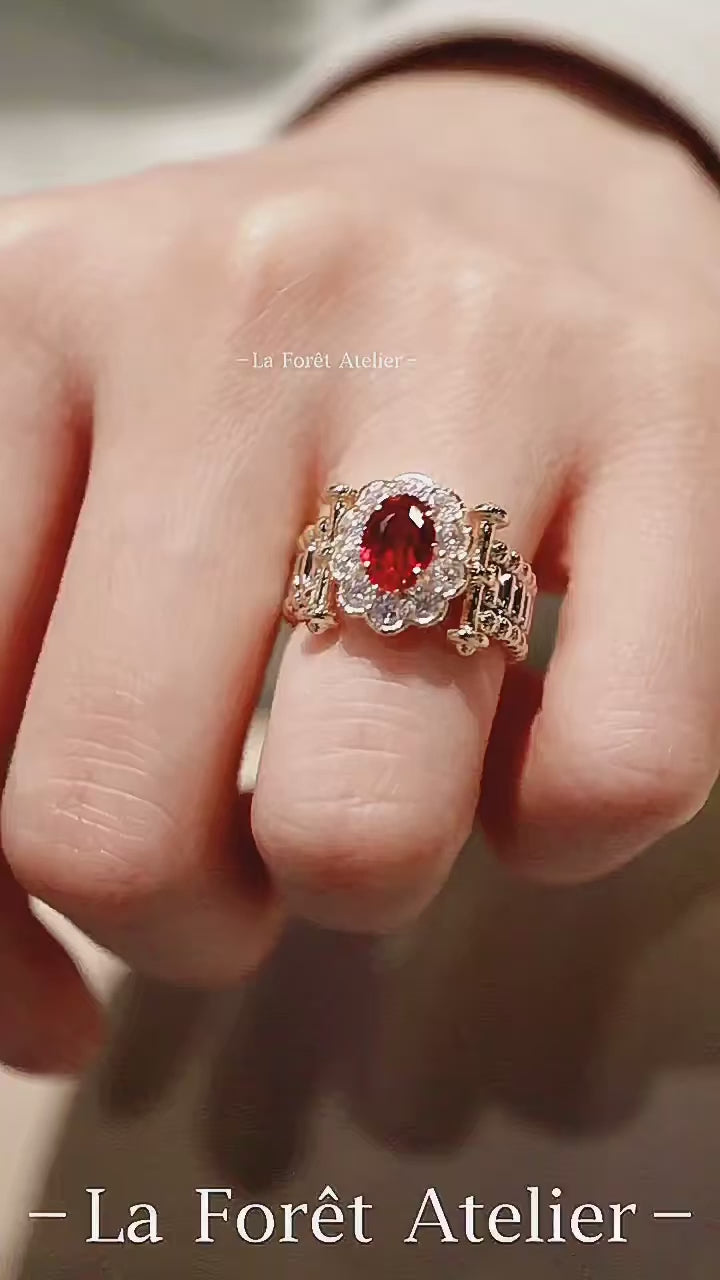 Oval pigeon blood ruby ring with scalloped diamond setting

