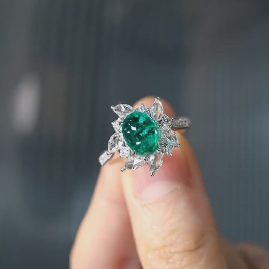 Floral halo ring with oval lab emerald and marquise diamonds








