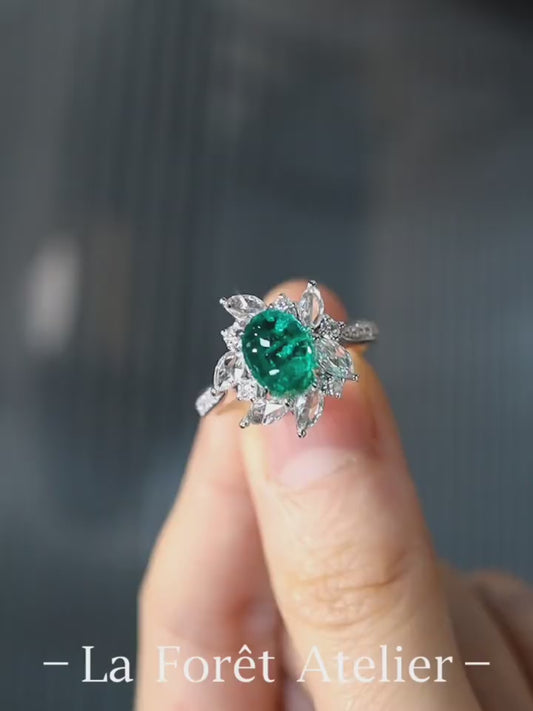 Floral halo ring with oval lab emerald and marquise diamonds








