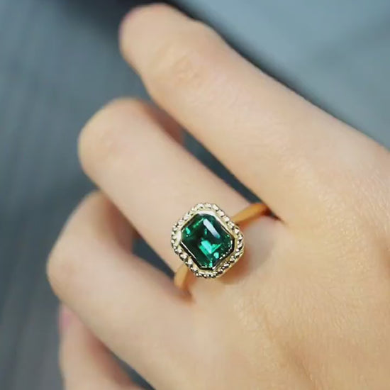 Belline ring with emerald-cut lab-grown emerald and diamond halo in gold setting








