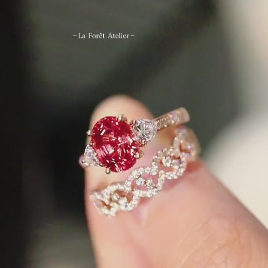 Three-piece padparadscha sapphire and diamond ring set with yellow gold bands and heart-cut accents








