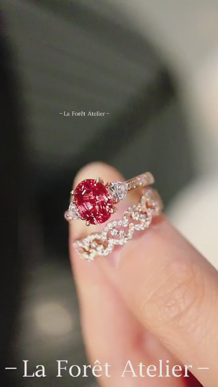 Three-piece padparadscha sapphire and diamond ring set with yellow gold bands and heart-cut accents








