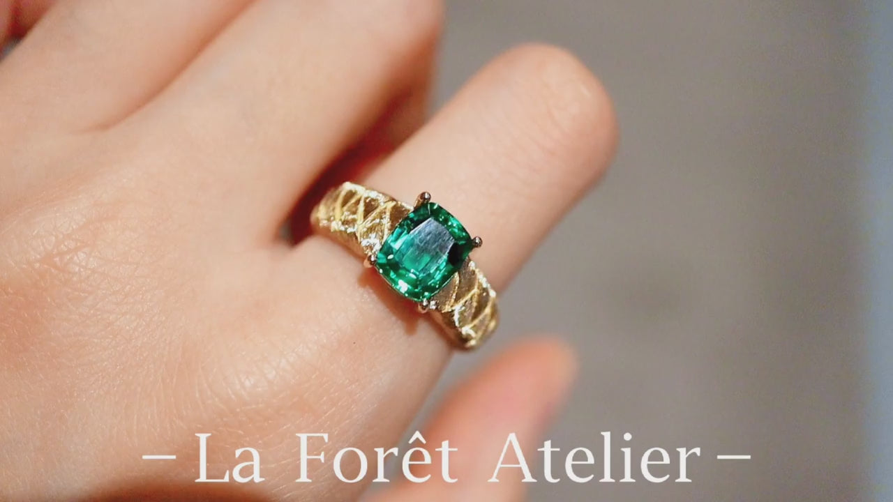 Rivelle ring with 2ct cushion-cut lab emerald set on a woven textured gold band