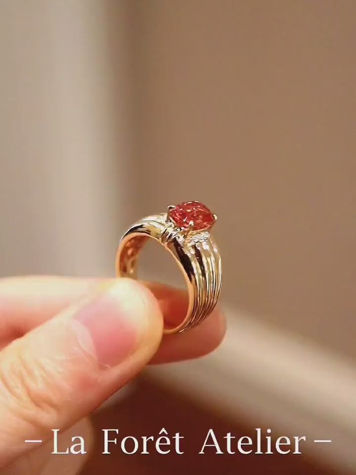 Gold ring with 2ct lab padparadscha sapphire and ribbed band design








