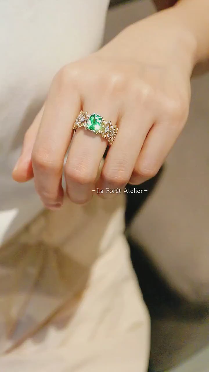 Green lab tsavorite engagement ring with sparkling diamond accents

