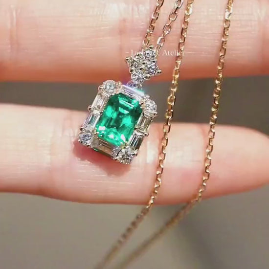 1.2ct emerald cut lab emerald pendant with diamond baguette halo on yellow gold chain








