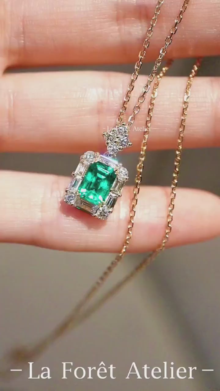 1.2ct emerald cut lab emerald pendant with diamond baguette halo on yellow gold chain








