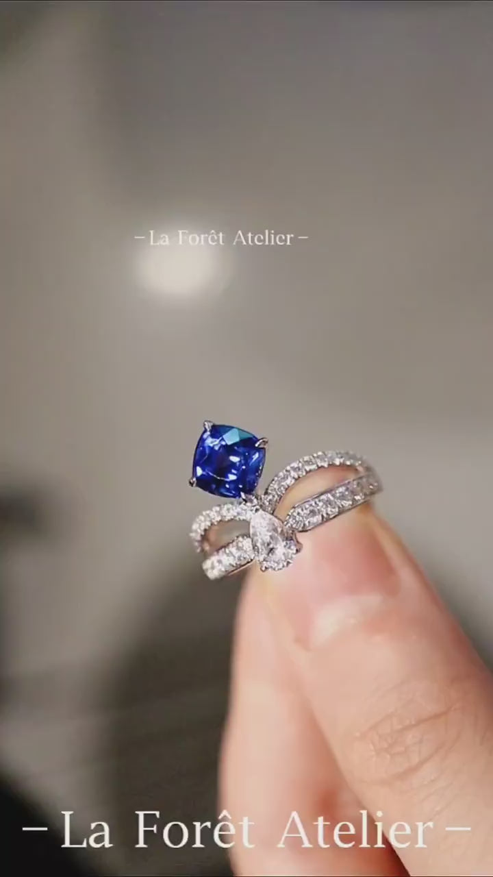 Elegant blue sapphire ring with pear diamond accent