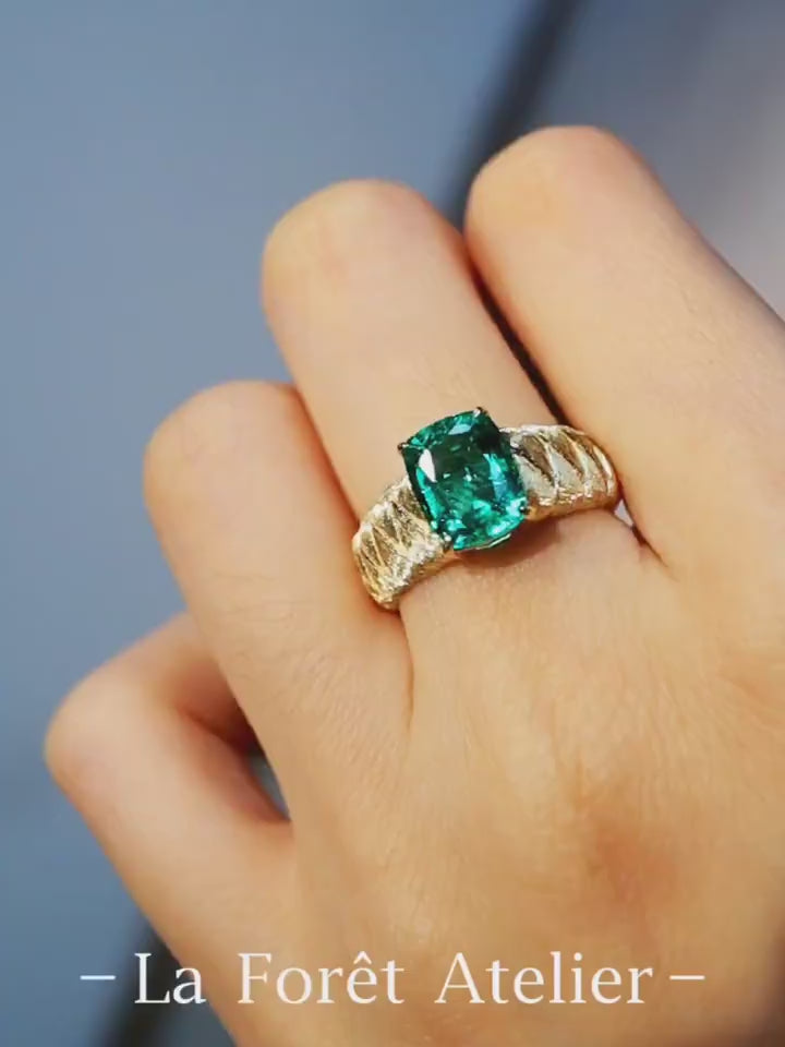 The Emerelle ring features a radiant 2ct lab grown emerald on a textured quilted gold band—a bold, elegant statement of timeless design.

