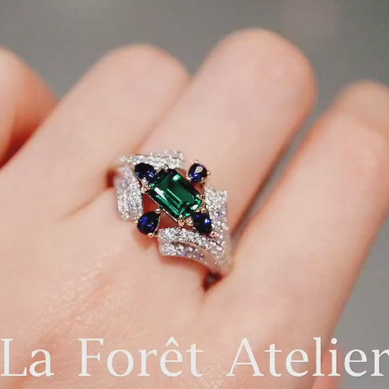 Elegant emerald-cut lab emerald ring with multi-stone design








