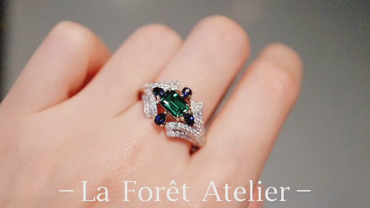 Elegant emerald-cut lab emerald ring with multi-stone design









